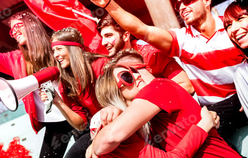 Preview: Friends football supporter fans hugging each other watching soccer match
