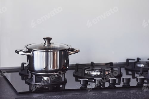 Preview: Close up view of top of a gas stove indoors near wall at daytime