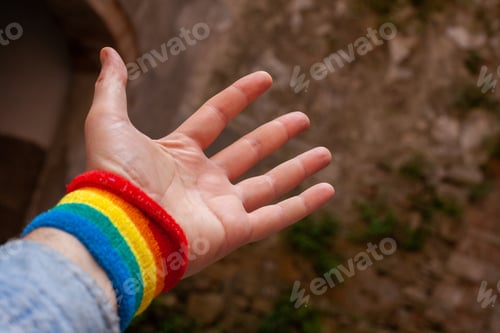 Preview: Closeup of a wide opened hand palm with a rainbow band