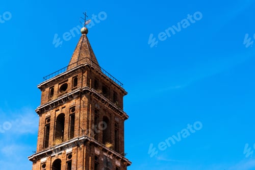 Preview: Skyline tower with cross on top against a clear blue sky background