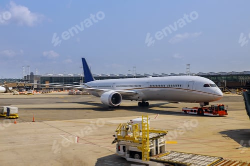Preview: Passenger plane at airport view with airplanes and service vehicles near boarding terminal