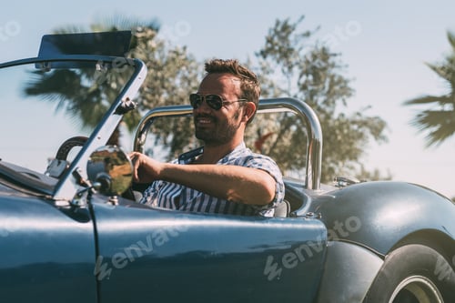 Preview: Man driving a convertible vintage car