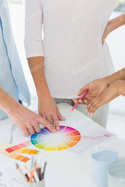 Preview: Interior Designer Showing Colour Wheel To Two Customers In Her Studio