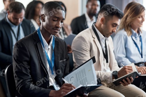 Preview: Shot of a group of businesspeople taking notes during a meeting in an office