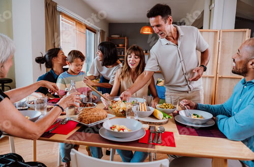Preview: Family and friends reunion at home. Happy multigenerational family enjoying meal together at home