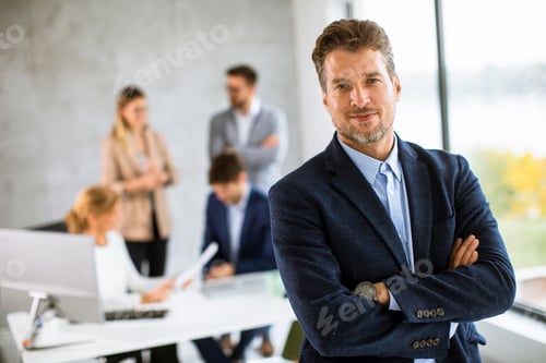 Preview: Handsome young business man standing confident in the office