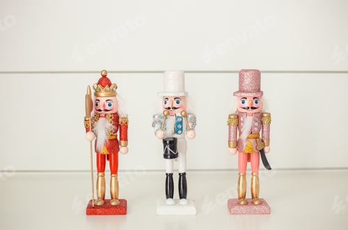 Preview: Red pink white and gold glittery nutcracker on a white background