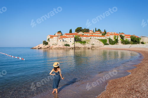 Preview: Adriatic Sea. A girl in a straw hat stands with a glass of wine