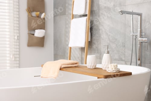 Preview: Set of different bath accessories and soap on tub in bathroom