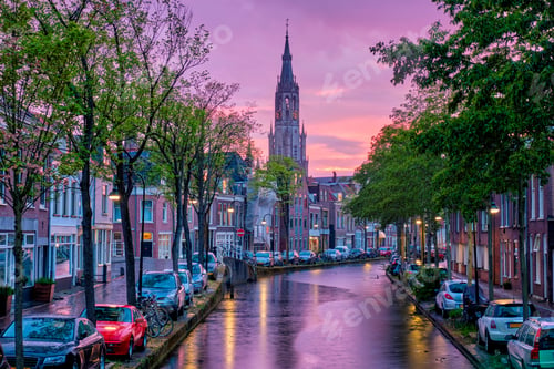 Preview: Canal with parked along cars in Delft town, Netherlands