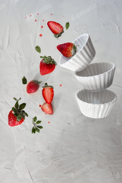 Preview: Red strawberries levitating on a white background. Levitation effect.
