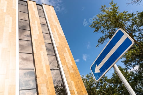 Preview: old road sign. white arrow on a blue background