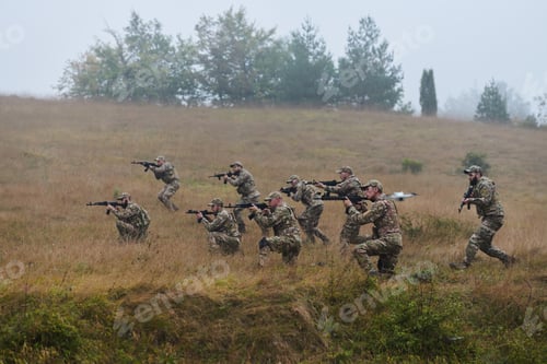 Preview: A disciplined and specialized military unit, donned in camouflage, strategically patrolling and
