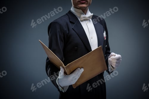 Preview: Professional man in tuxedo holding tan folder