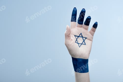 Preview: cropped view of female hand with national star of david isolated on blue