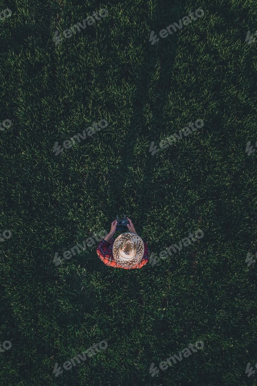 Preview: Wheat farmer using drone remote controller in wheatgrass field, aerial