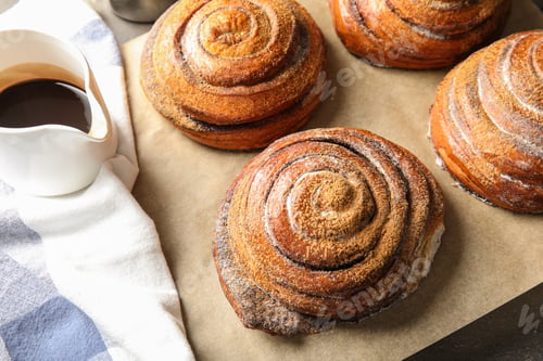 Preview: Cinnamon rolls and jug with chocolate syrup on table