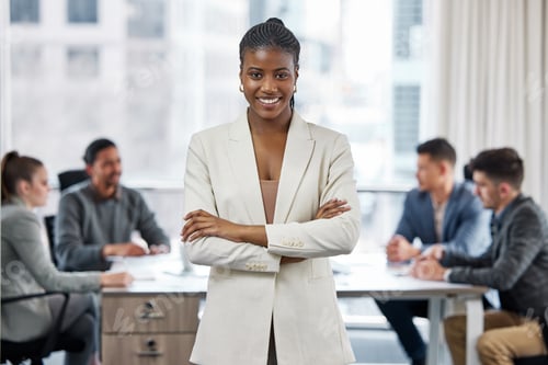 Preview: Shot of a young businesswoman standing with her arms crossed in a meeting at work