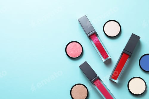 Preview: Composition of lipsticks and eyeshadows on color background, flat lay. Space for text