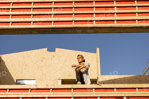 Preview: Man on construction site of a wooden frame house