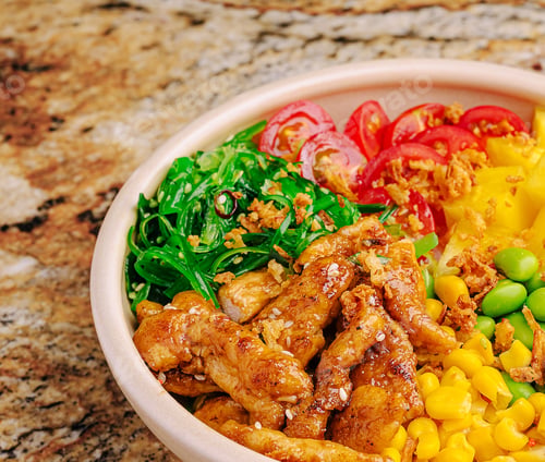Preview: Colorful bowl of chicken, vegetables, and grains on a granite countertop