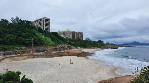 Preview: An empty beach shore with buildings in the background