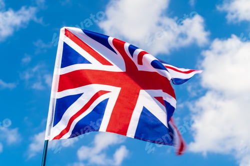 Preview: United Kingdom Flag waving on wind in blue sky