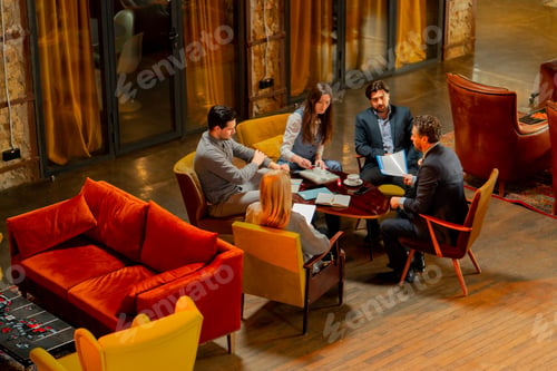 Preview: top shot in large beautiful hall office employees sitting on yellow chairs discuss a deal