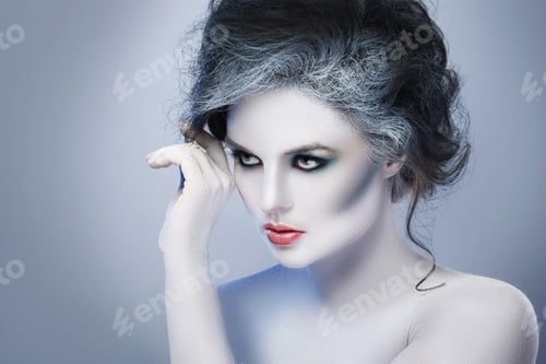 Preview: Woman in white body-art in creative image of winter, snow queen, or another sad or evil character
