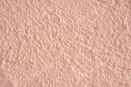 Preview: Textured Plaster Wall Background with Earthy Pink Hue