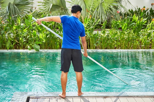 Preview: Young man cleaning pool
