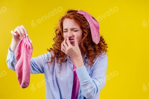 Preview: curly ginger redhead woman in a cotton shirt gesture smells bad