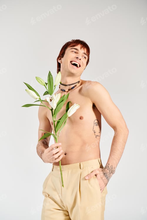 Preview: Blossoming beauty: man holding flower