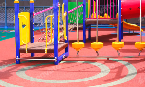 Preview: Colorful playground equipment on rubber floor in outdoors playground area at kindergarten school