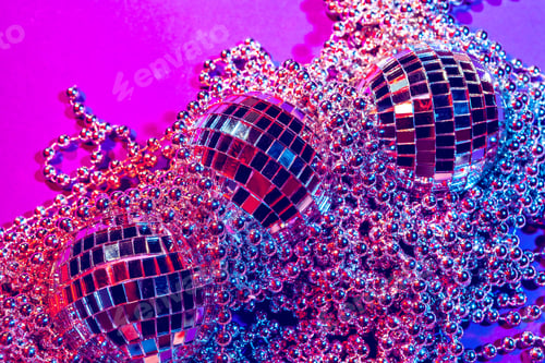 Preview: Shiny small disco balls sparkling in a beautiful purple light. Disco party concept
