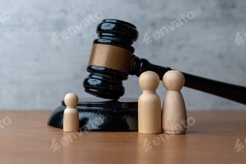 Preview: A wooden gavel stands next to three wooden peg dolls.