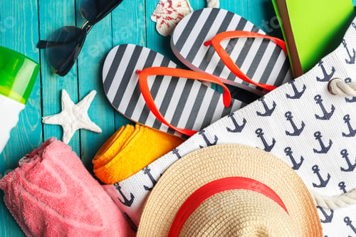 Preview: Beach accessories on wooden table.