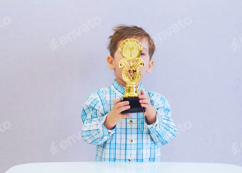 Preview: funny boy age three years old, holding in holding a trophy