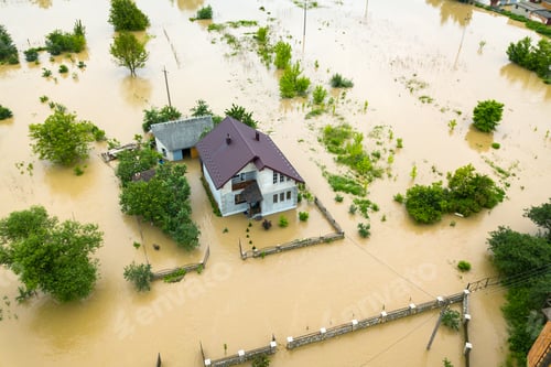 Preview: Aerial view of flooded house with dirty water all around it.
