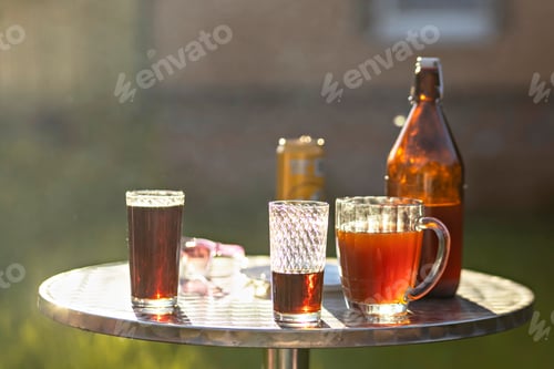 Vista previa: Different colored drinks on a table in the backyard of a country house