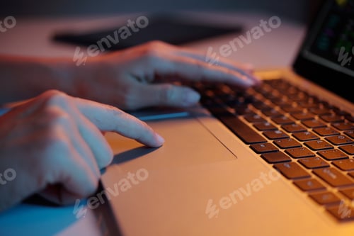 Preview: Typing on Laptop Keyboard in Dimly Lit Room