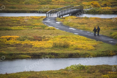 Preview: Couple walking in Rift Valley, Thingvellir (Pingvellir) National Park, The Golden Circle, Iceland, E