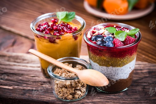 Vista previa: Colorful and healthy natural desserts in jar with chia