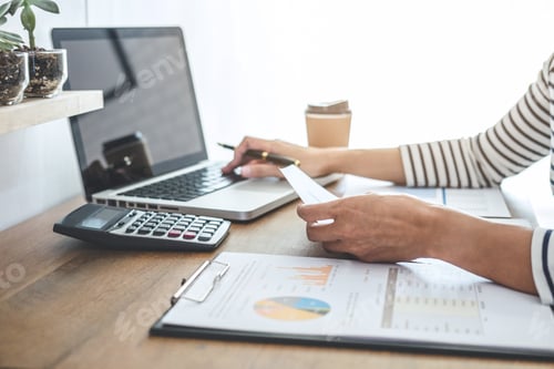 Preview: Female accountant calculations, audit and analyzing financial graph data with calculator and laptop