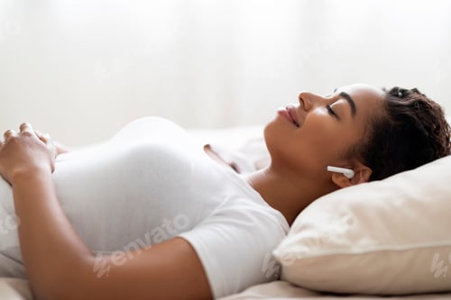 Preview: Relax Concept. Smiling Young Black Female Listening Music While Lying In Bed