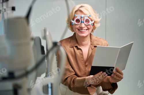 Preview: Smiling client at stage of eye test to select glasses