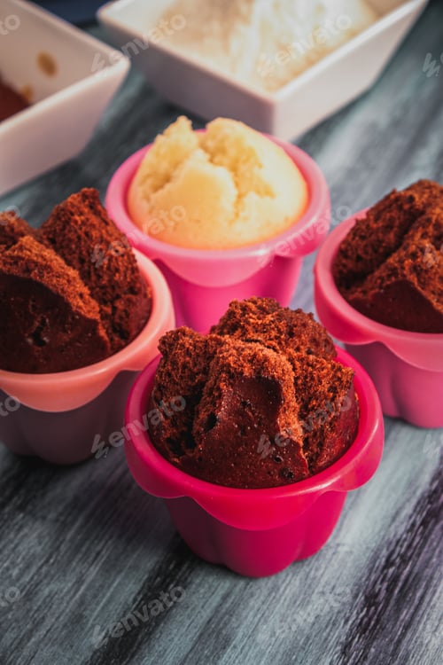 Preview: Homemade Japanese muffins with cocoa and vanilla on colored wooden surface