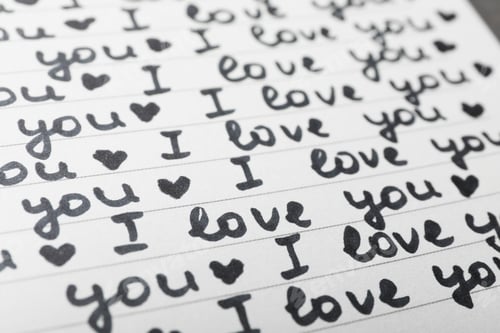 Preview: Notebook page with words I LOVE YOU and hearts as background, closeup