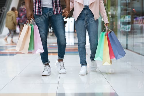 Preview: Shopping Together. Unrecognizable Couple Walking With Lots Of Shopper Bags In Mall