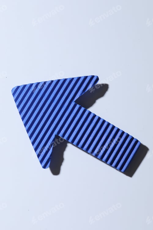 Preview: One blue paper arrow on white background, top view